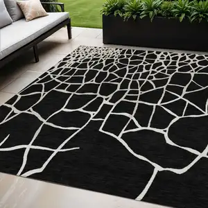 Photo of Black And Beige Abstract Washable Indoor Outdoor Area Rug