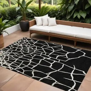 Photo of Black And Beige Abstract Washable Indoor Outdoor Area Rug