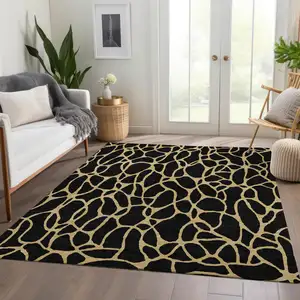 Photo of Black And Gold Geometric Washable Area Rug With UV Protection