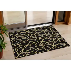 Photo of Black And Gold Geometric Washable Indoor Outdoor Area Rug