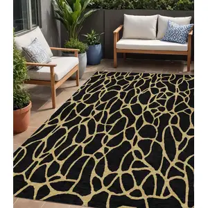 Photo of Black And Gold Geometric Washable Indoor Outdoor Area Rug