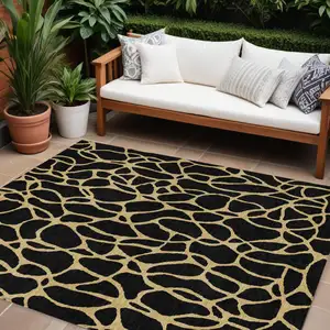 Photo of Black And Gold Geometric Washable Indoor Outdoor Area Rug