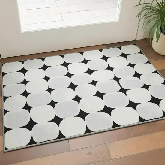 Black And Ivory Abstract Geometric Washable Area Rug With UV Protection Photo 2