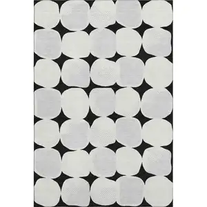 Photo of Black And Ivory Abstract Geometric Washable Area Rug With UV Protection