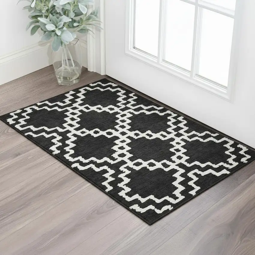 Black And Ivory Abstract Geometric Washable Area Rug With UV Protection Photo 2