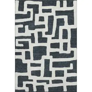 Photo of Black And Ivory Abstract Geometric Washable Area Rug With UV Protection