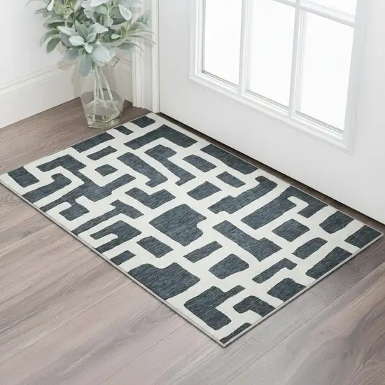 Black And Ivory Abstract Geometric Washable Area Rug With UV Protection Photo 2