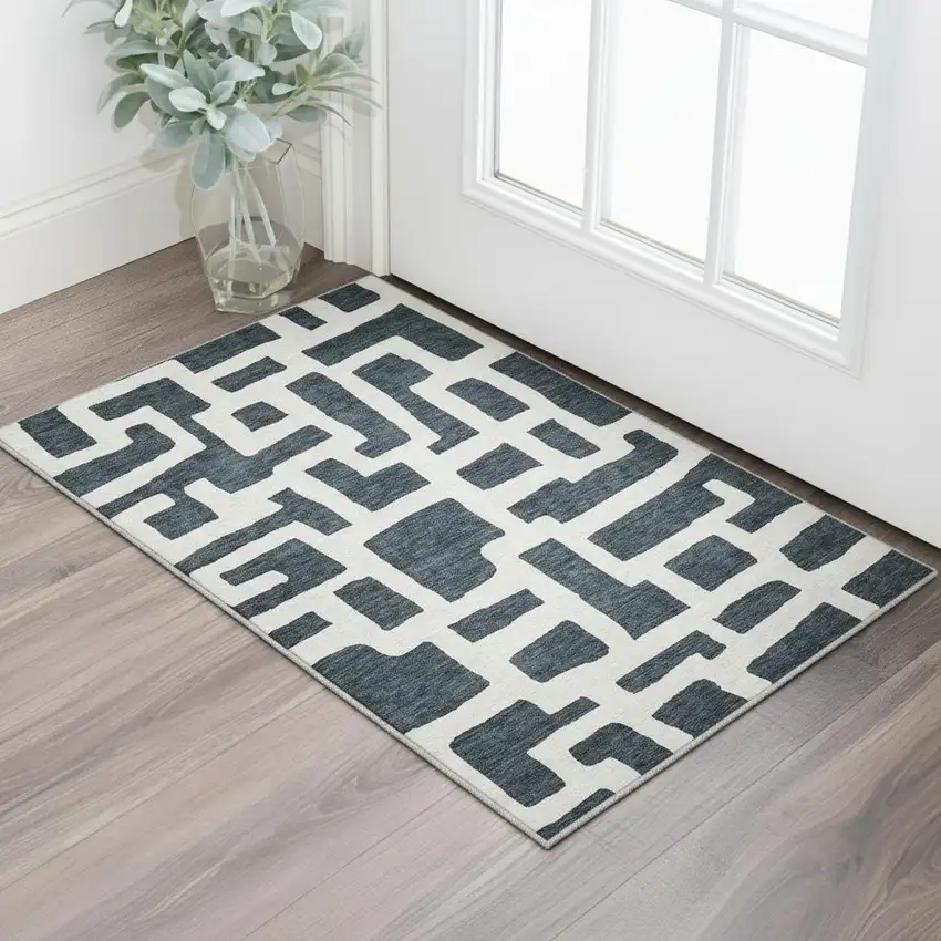 Black And Ivory Abstract Geometric Washable Area Rug With UV Protection Photo 2