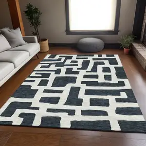 Photo of Black And Ivory Abstract Geometric Washable Area Rug With UV Protection