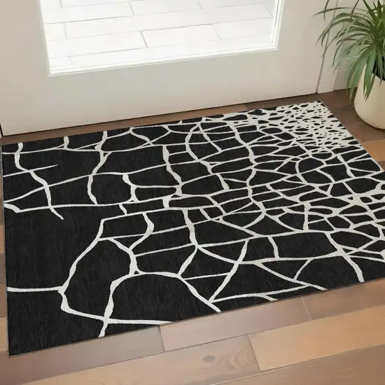 Black And Ivory Abstract Geometric Washable Area Rug With UV Protection Photo 1