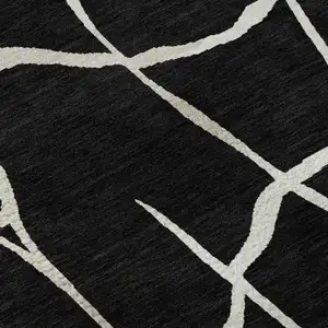 Photo of Black And Ivory Abstract Geometric Washable Area Rug With UV Protection