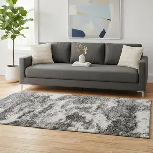 Photo of Black And Ivory Abstract Washable Area Rug With UV Protection