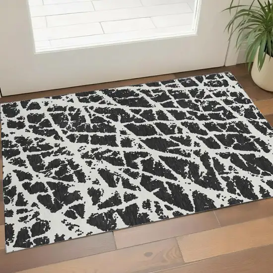 Black And Ivory Abstract Washable Area Rug With UV Protection Photo 1