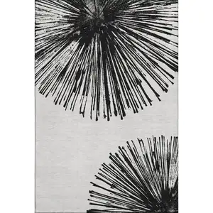 Photo of Black And Ivory Abstract Washable Area Rug With UV Protection