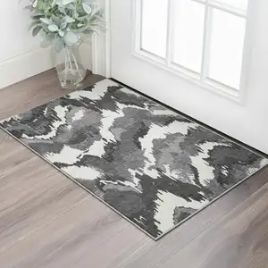 Photo of Black And Ivory Abstract Washable Area Rug With UV Protection