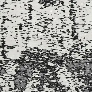 Photo of Black And Ivory Abstract Washable Area Rug With UV Protection