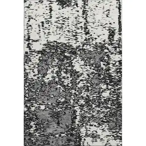 Photo of Black And Ivory Abstract Washable Area Rug With UV Protection