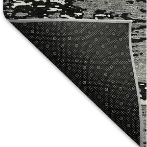 Photo of Black And Ivory Abstract Washable Area Rug With UV Protection