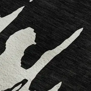 Photo of Black And Ivory Abstract Washable Area Rug With UV Protection