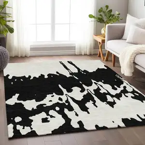 Photo of Black And Ivory Abstract Washable Area Rug With UV Protection