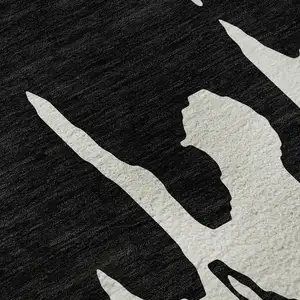 Photo of Black And Ivory Abstract Washable Area Rug With UV Protection