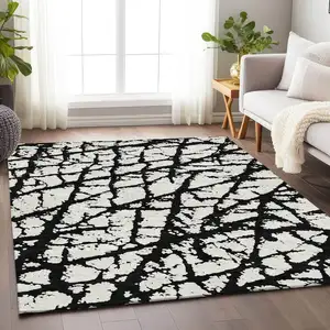 Photo of Black And Ivory Abstract Washable Area Rug With UV Protection