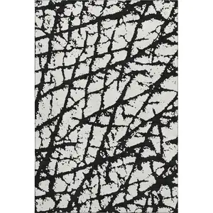Photo of Black And Ivory Abstract Washable Area Rug With UV Protection