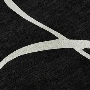 Photo of Black And Ivory Abstract Washable Area Rug With UV Protection