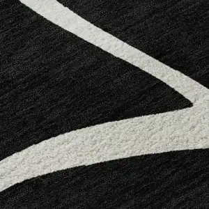 Photo of Black And Ivory Abstract Washable Area Rug With UV Protection