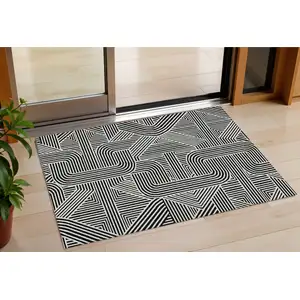 Photo of Black And Ivory Abstract Washable Indoor Outdoor Area Rug
