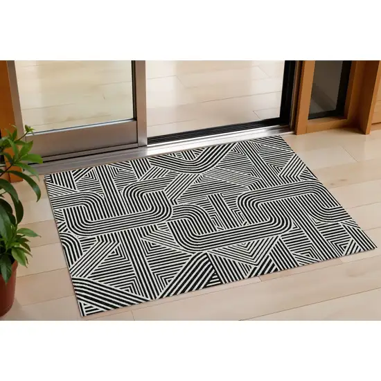 Black And Ivory Abstract Washable Indoor Outdoor Area Rug Photo 1