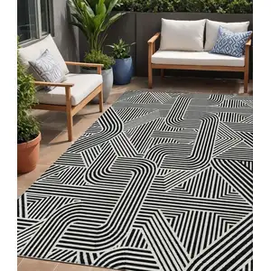 Photo of Black And Ivory Abstract Washable Indoor Outdoor Area Rug