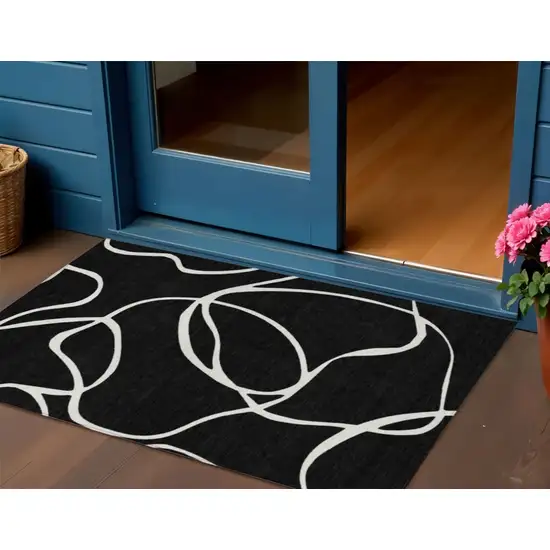 Black And Ivory Abstract Washable Indoor Outdoor Area Rug Photo 1