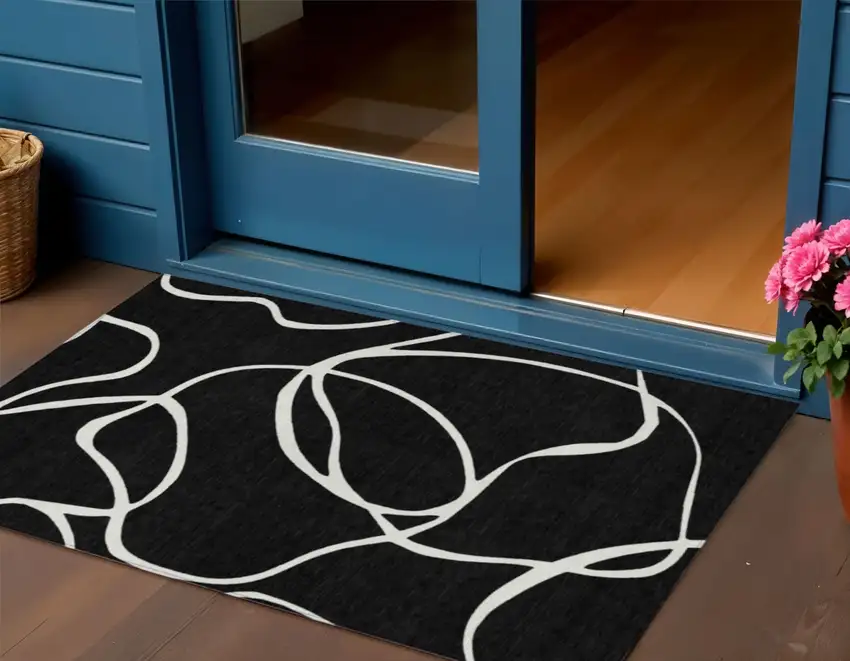 Black And Ivory Abstract Washable Indoor Outdoor Area Rug Photo 1
