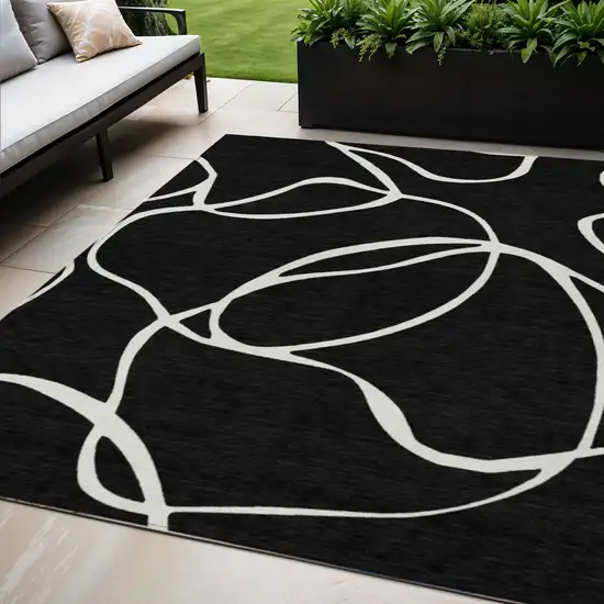 Black And Ivory Abstract Washable Indoor Outdoor Area Rug Photo 1