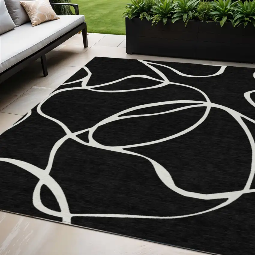 Black And Ivory Abstract Washable Indoor Outdoor Area Rug Photo 1