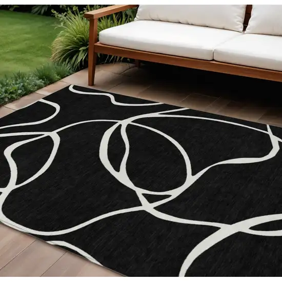 Black And Ivory Abstract Washable Indoor Outdoor Area Rug Photo 1