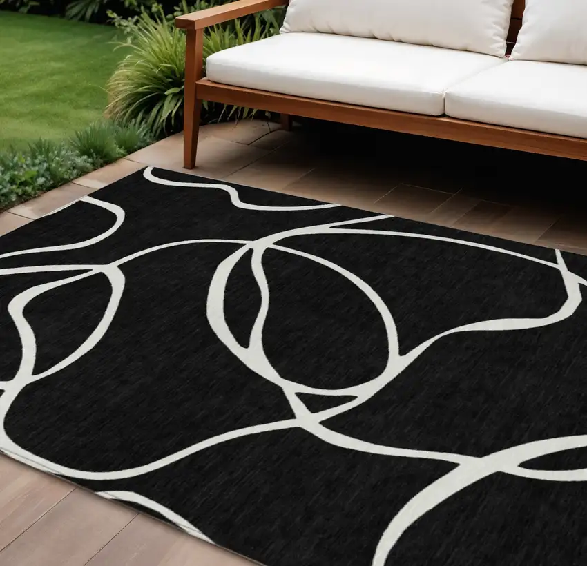 Black And Ivory Abstract Washable Indoor Outdoor Area Rug Photo 1
