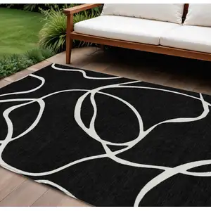 Photo of Black And Ivory Abstract Washable Indoor Outdoor Area Rug