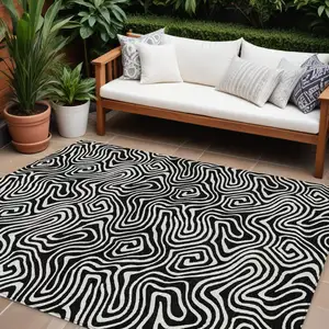 Photo of Black And Ivory Abstract Washable Indoor Outdoor Area Rug