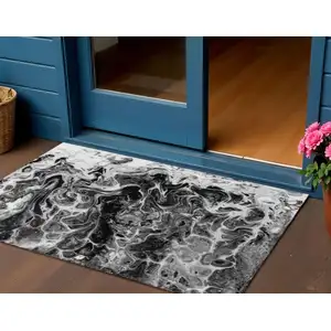 Photo of Black And Ivory Abstract Washable Indoor Outdoor Area Rug