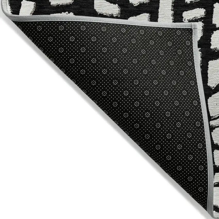 Black And Ivory Abstract Washable Indoor Outdoor Area Rug Photo 2