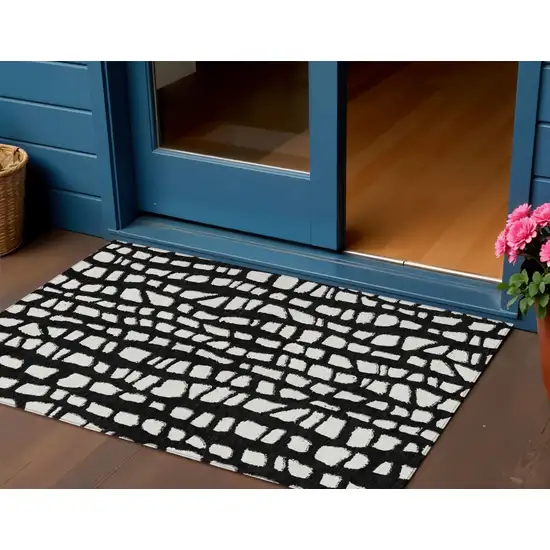 Black And Ivory Abstract Washable Indoor Outdoor Area Rug Photo 1