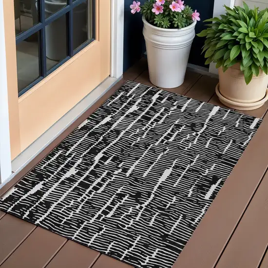 Black And Ivory Abstract Washable Indoor Outdoor Area Rug Photo 1