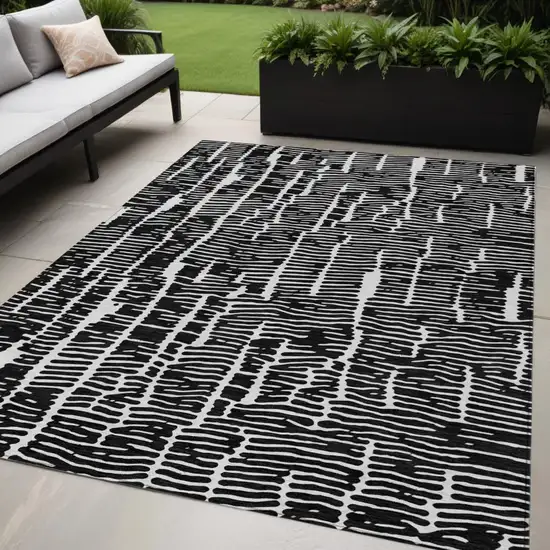 Black And Ivory Abstract Washable Indoor Outdoor Area Rug Photo 1