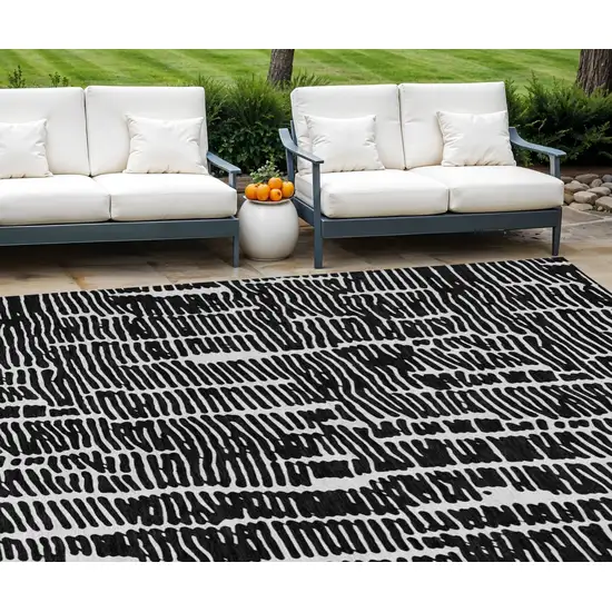 Black And Ivory Abstract Washable Indoor Outdoor Area Rug Photo 1