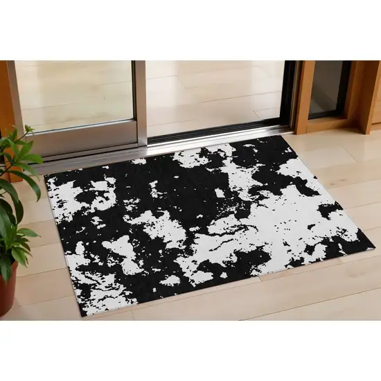 Black And Ivory Abstract Washable Indoor Outdoor Area Rug Photo 1