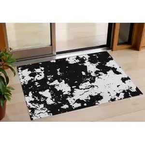 Photo of Black And Ivory Abstract Washable Indoor Outdoor Area Rug