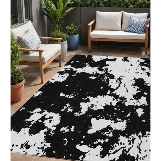 Black And Ivory Abstract Washable Indoor Outdoor Area Rug Photo 1
