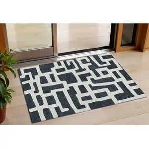 Photo of Black And Ivory Abstract Washable Indoor Outdoor Area Rug